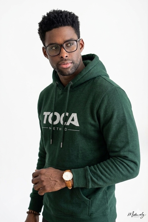 Studio portrait of Dawou Tarraxo wearing the TOCA Method hoodie — pioneer of Tarraxo and creator of the TOCA Method